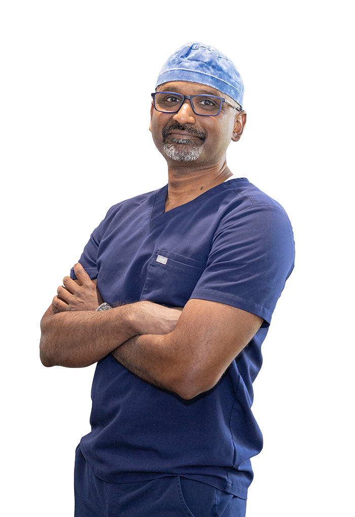 Dr. Sajid Syed of Fusion Implant Dentistry wearing surgical scrubs
